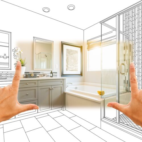 home improvement contractors Hands frame a bathroom remodel rendering with a vanity, a tub, and a glass shower in a bright design sketch.